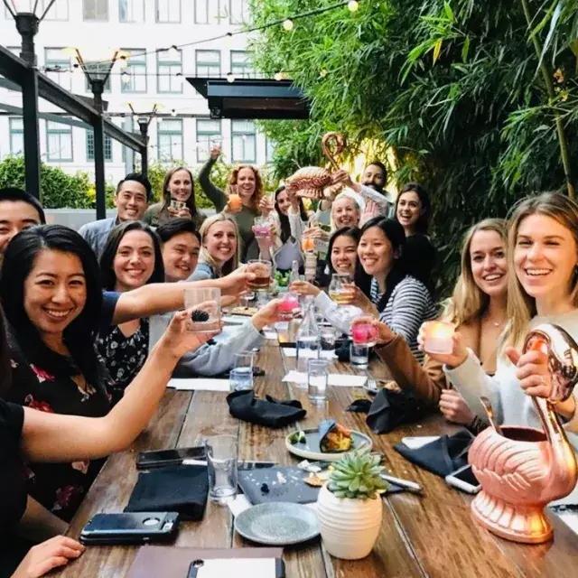 A group of people toasting at Dirty Habit